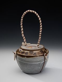 Image - Ceramic teapot with tall hooped leather and rope handle